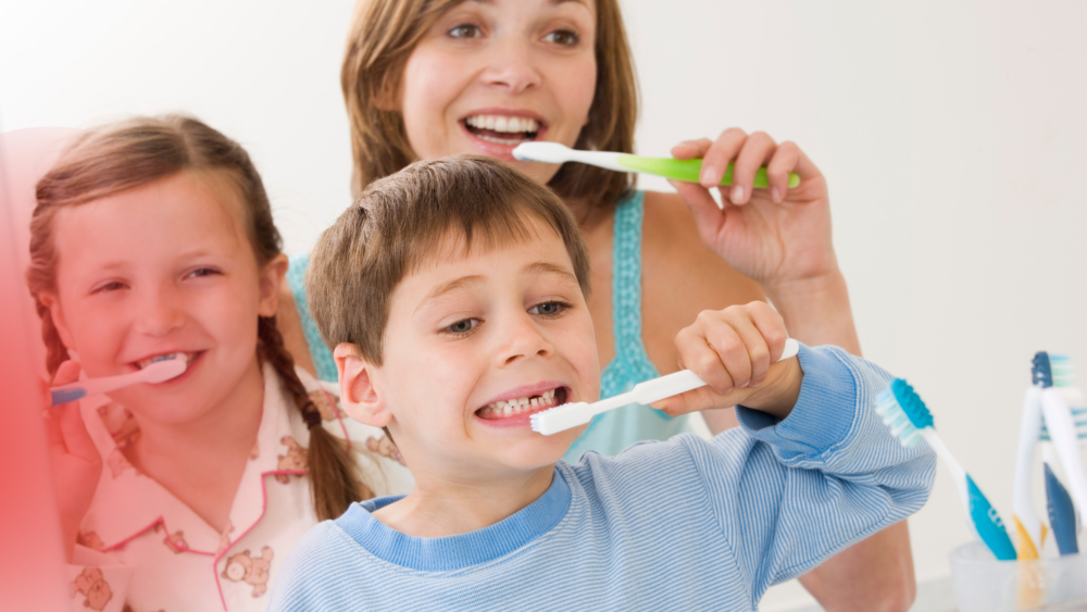 Mother and two children brushing teeth