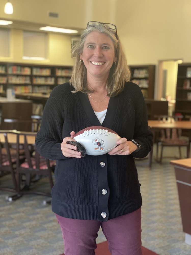 Woman in blue sweater with football