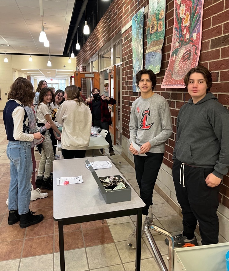 Students gathered at a table buying suckers￼