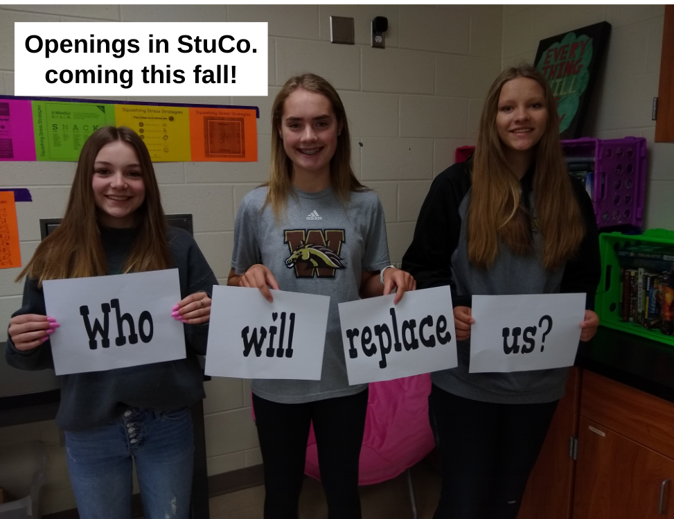 3 8th grader StuCo. members holding a sign asking, "Who will replace us?"