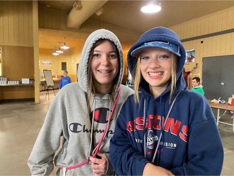 Two young girls wearing hooded sweatshirts