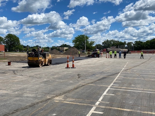 Construction workers putting asphalt down on the Linden High School Student Parking Lot