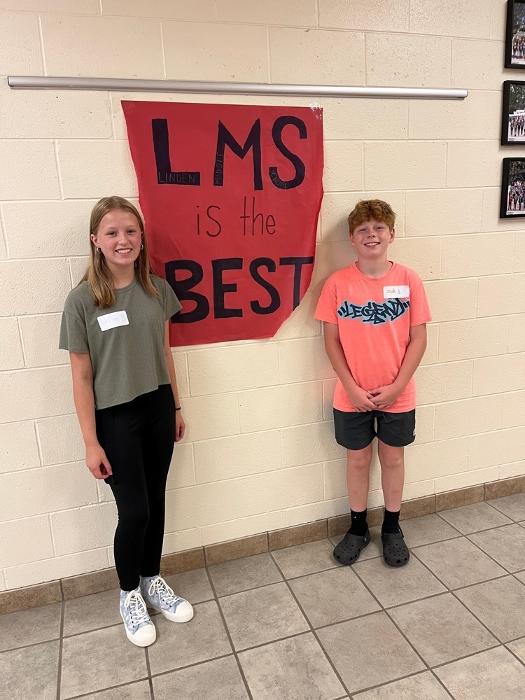 students standing with an LMS sign