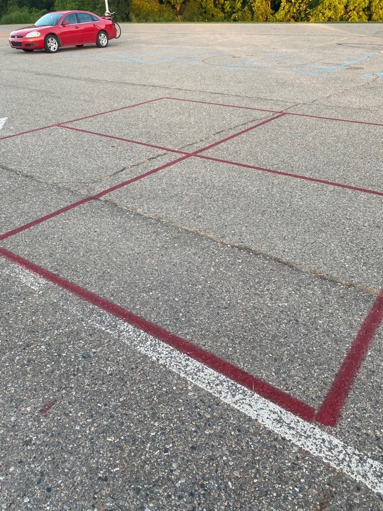 blacktop with red four-square template painted 