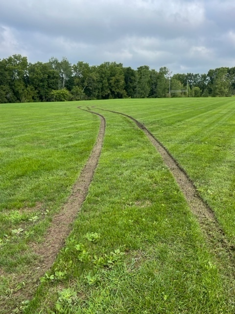 LMS practice field with car tracks through it.