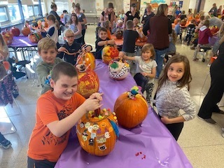 Children sharing their decorated pumpkins.