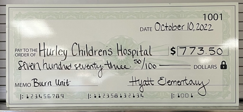 Picture of check amount donated to Hurley Hospital.