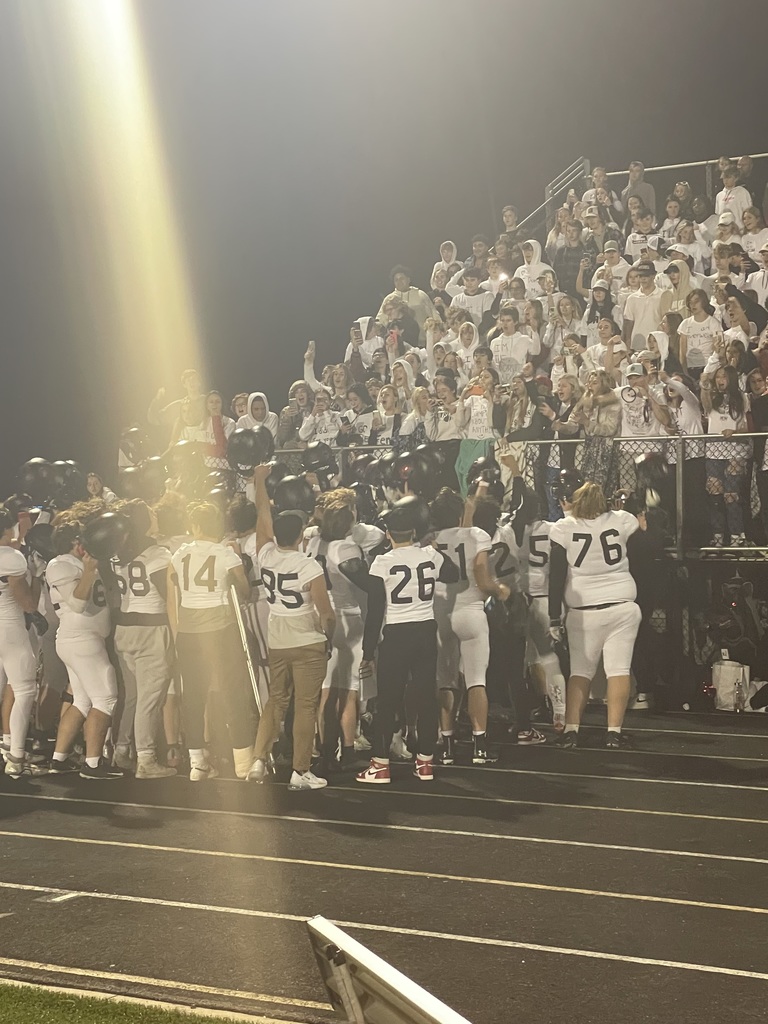 Football team cheering in front of student section
