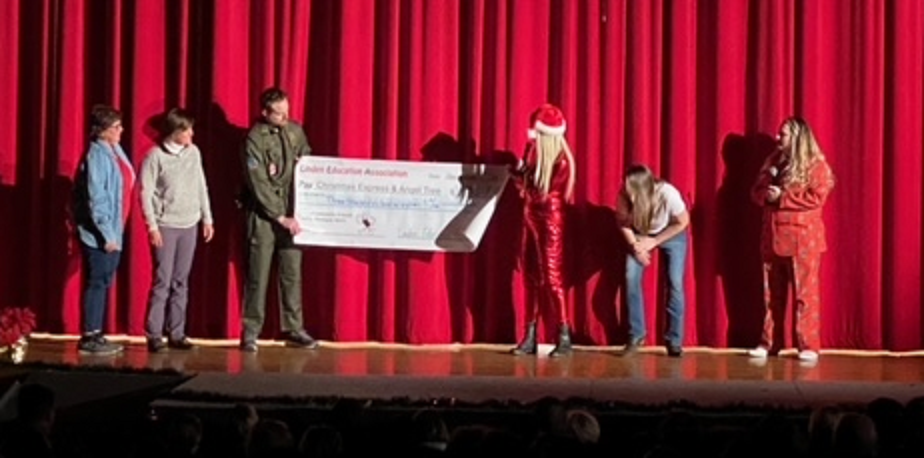large check display for donation from LCS faculty follies