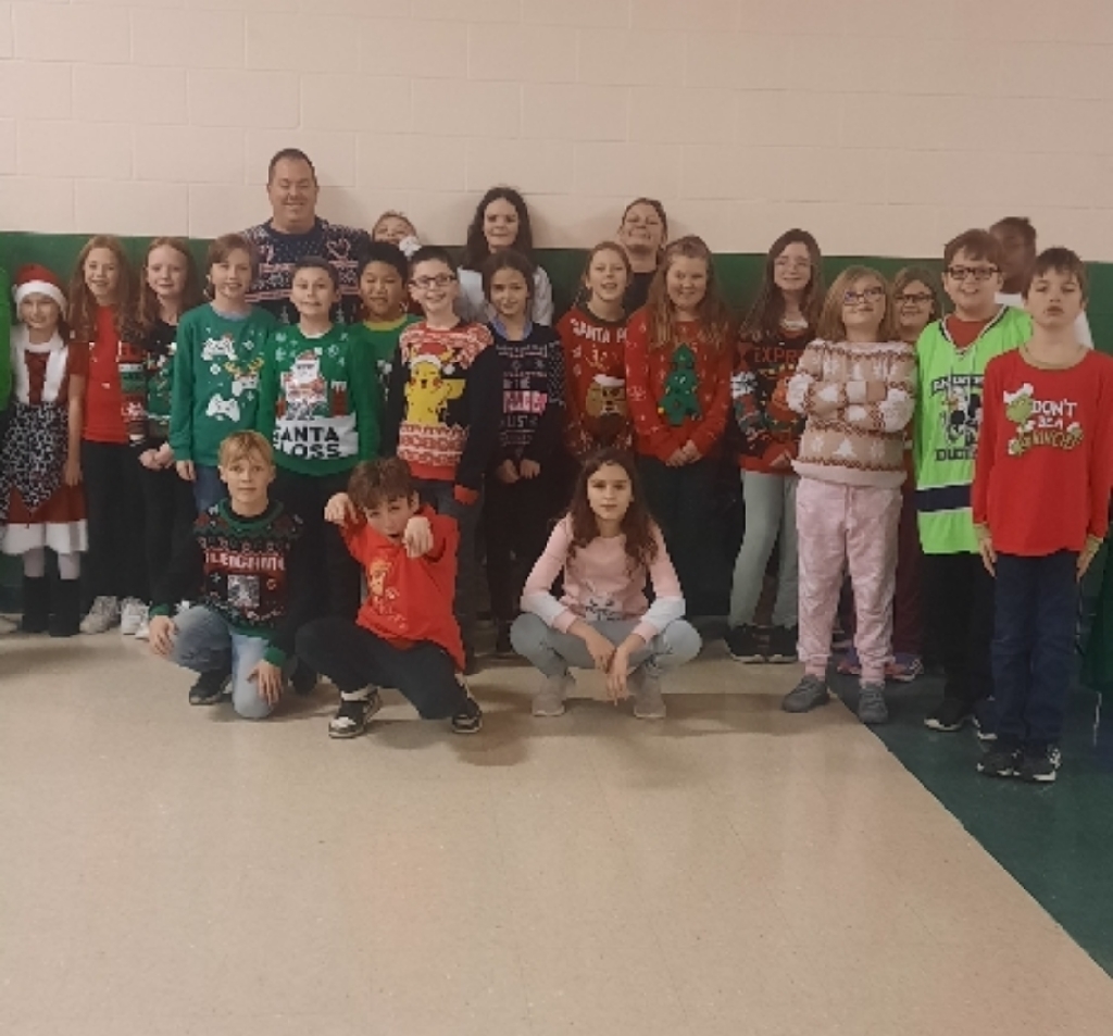 bunch of students wearing tacky holiday sweaters.