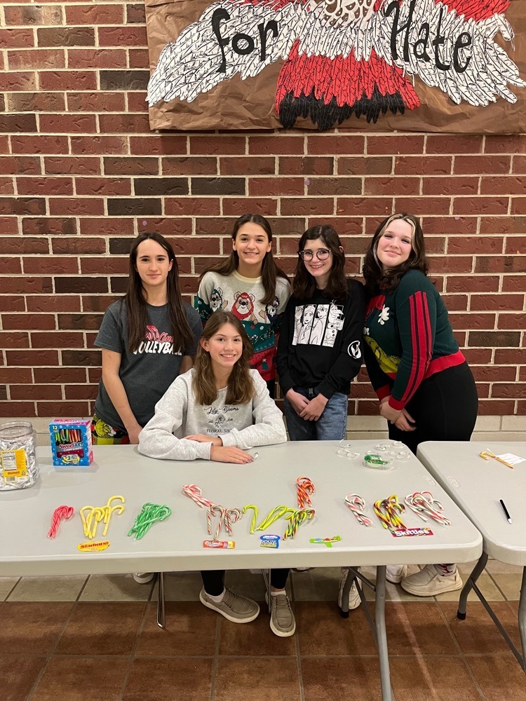 Group of students selling candy canes at a table