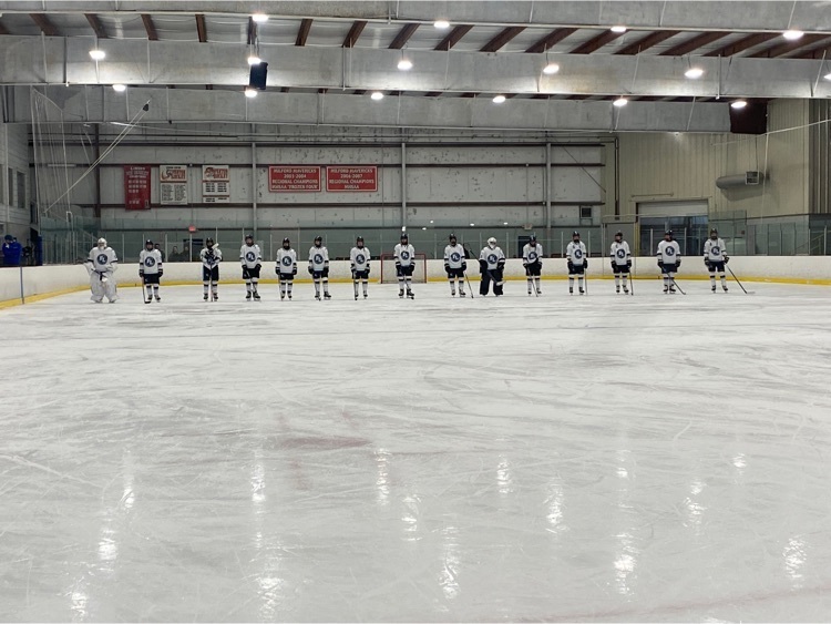 hockey team lined up on blue line for national anthem