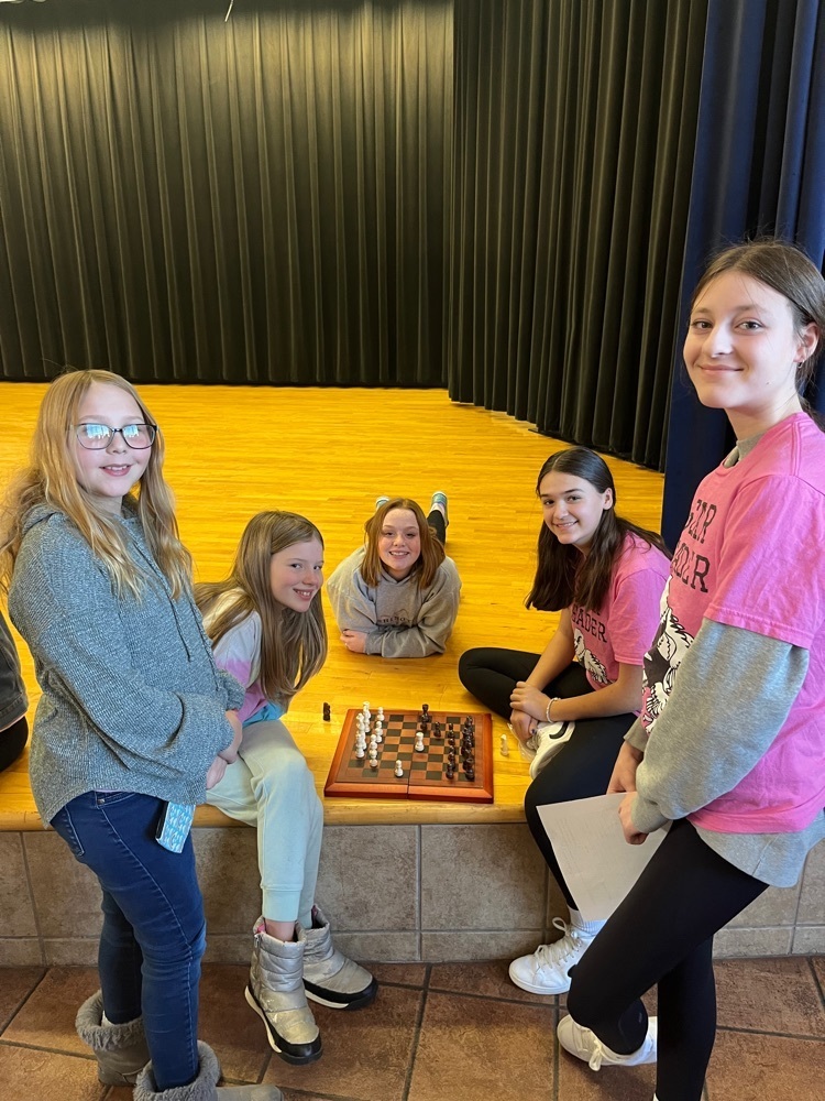 students playing chess on the stage
