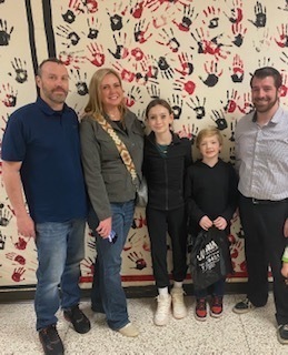 Picture of Hyatt Elementary family and a teacher in front of a hallway wall.  