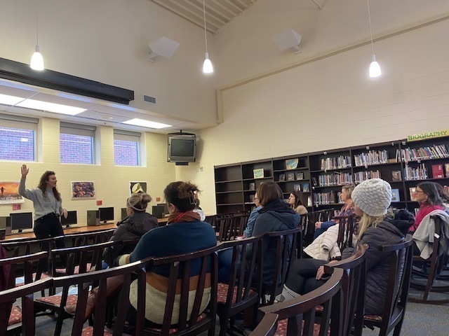 parents sitting in chairs listening to speaker on adolescent resilience