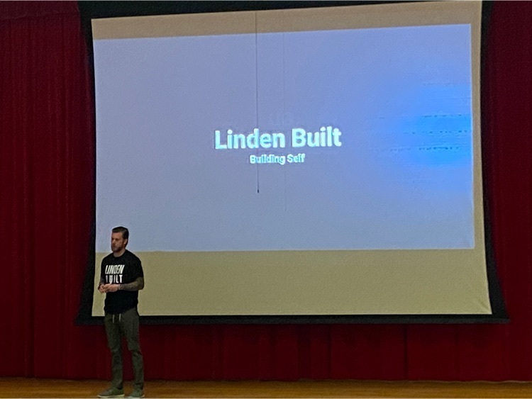 speaker with presentation screen behind