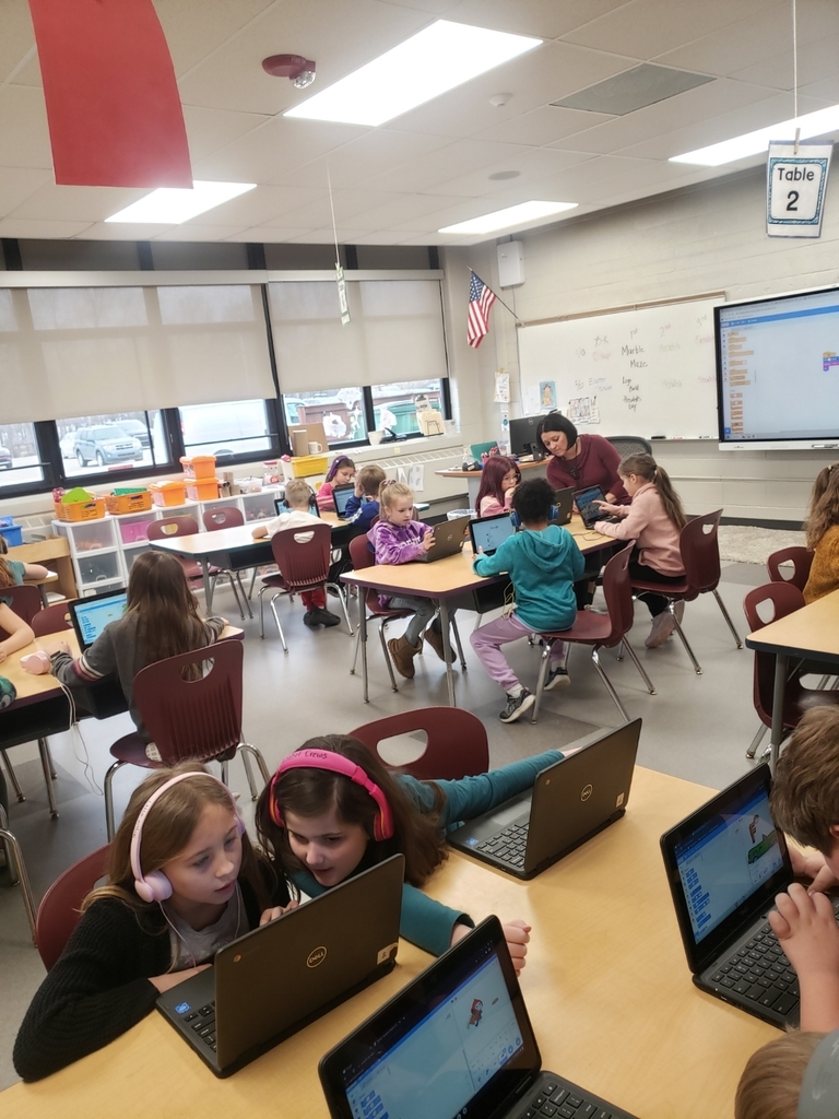 Students on chromebooks coding with Scratch.