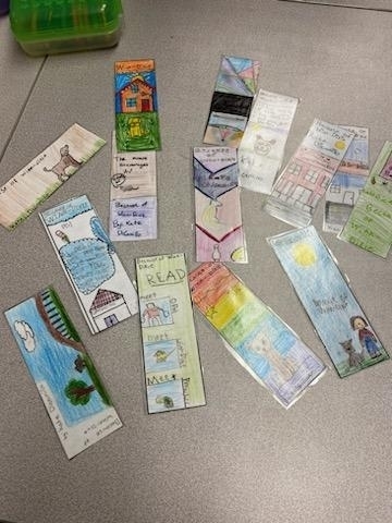 several student made bookmarks laid on a table.