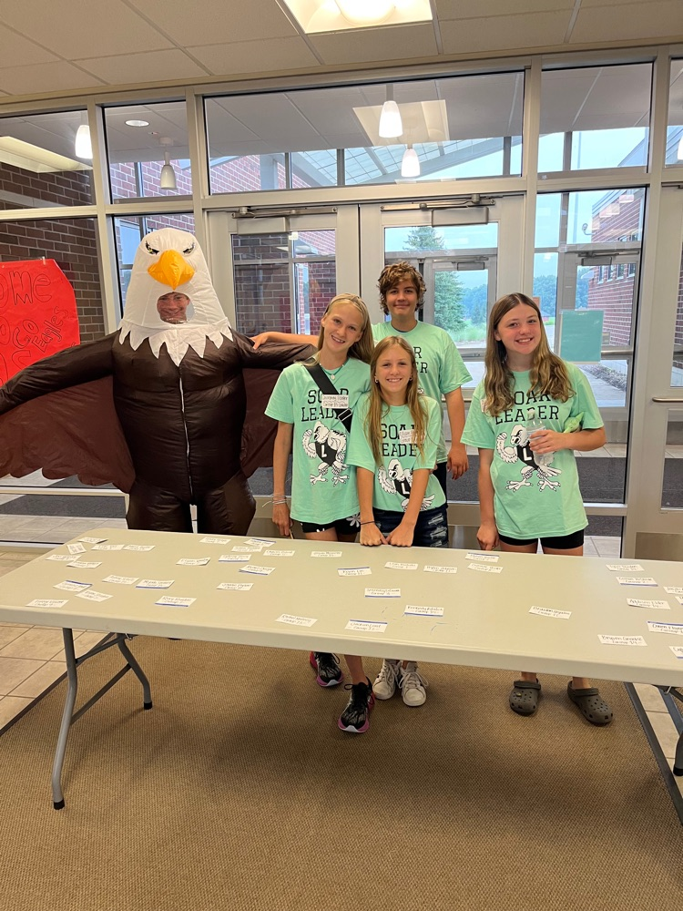 student an eagle costume next to four other students